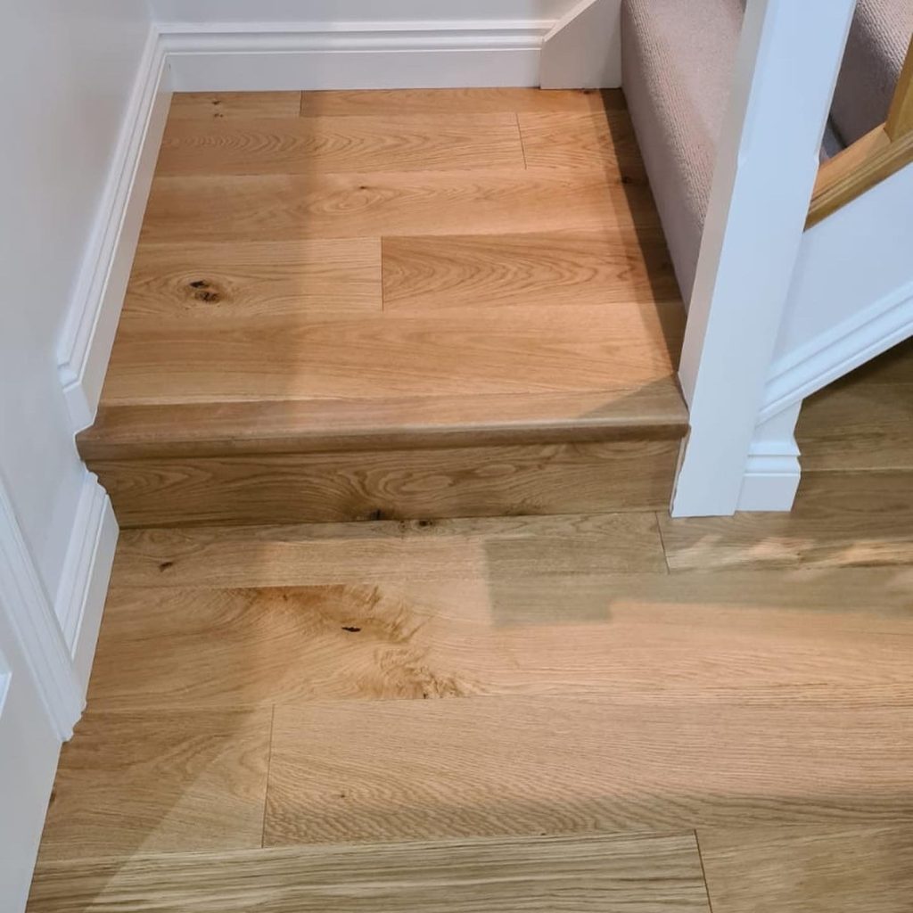 wide plank oak wood floor in open plan kitchen diner